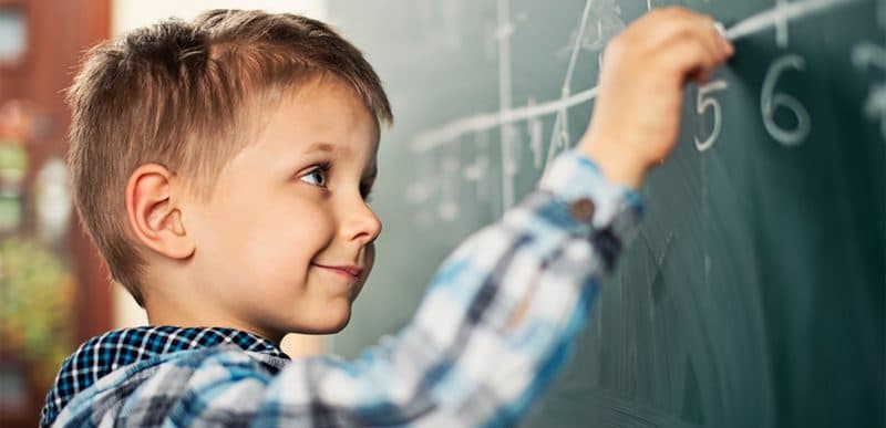 Boy writing on the chalkboard
