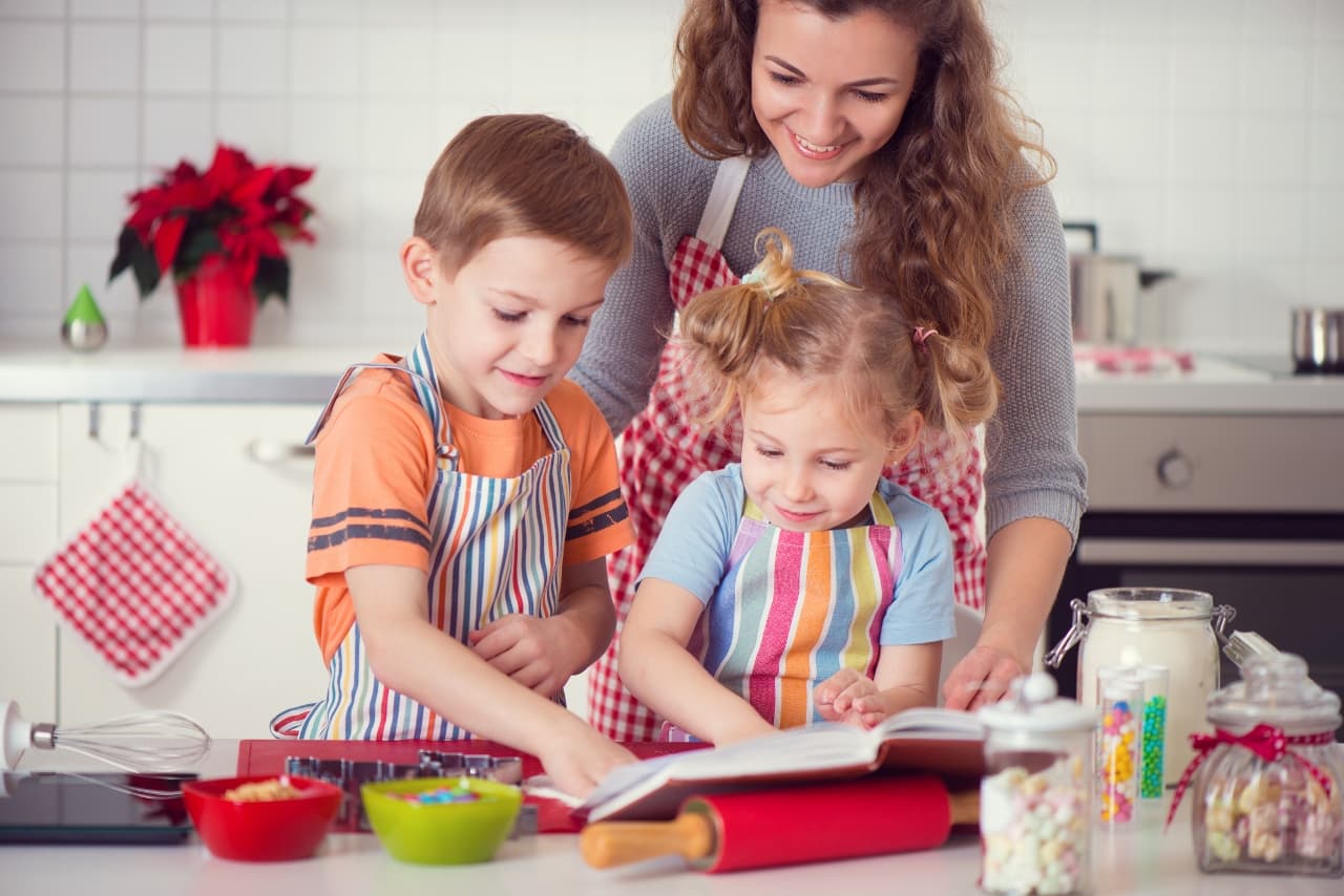 a mother doing baking actives with her two kids