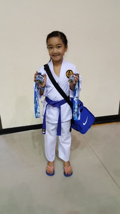 Emma with her Karate medals