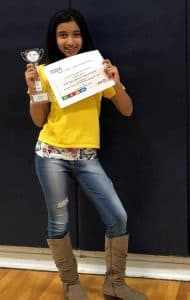Anvita holding an award