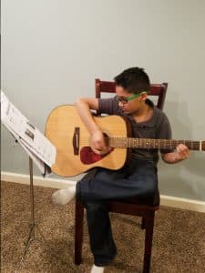 Atharv playing the guitar
