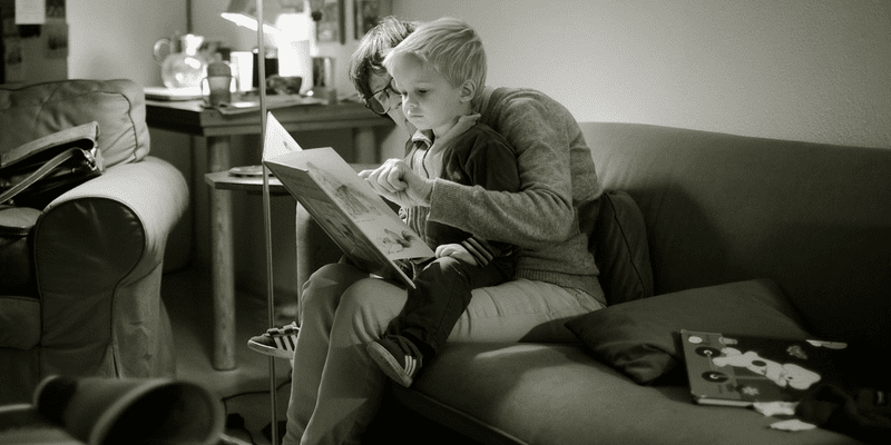 Mom reading to her son