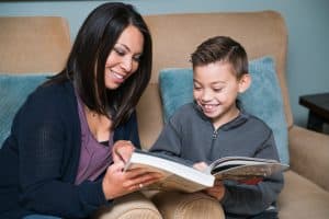son and mother reading together