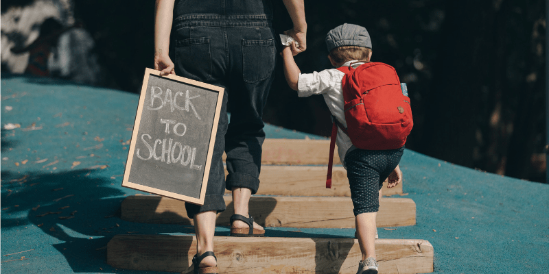 Child and mom walking in on the first day with a plan on how to ace school