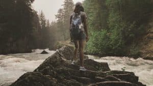 Inara standing on rocks in scouts