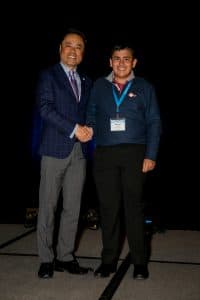 Ahmed shakes hands with Kumon President Mino Tanabe
