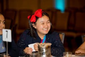 Christine laughing while participating at the Student Conference.