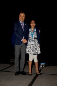 Praksitha shakes hands with Kumon North America President Mino Tanabe