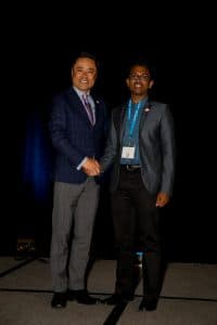 Isaac shaking hands with KNA President MIno Tanabe