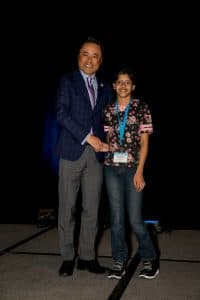 Sarvagna shakes hands with Kumon North America President Mino Tanabe