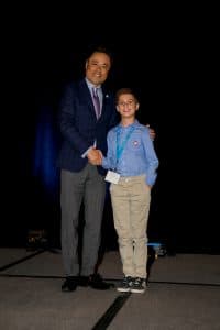 Sebastian shakes hands with Kumon North America President Mino Tanabe