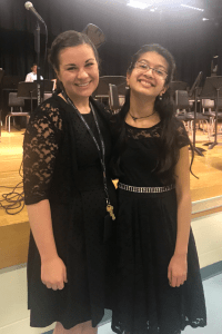 Somya poses at a violin recital