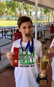 Sebastian holding various medals and trophies