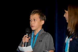Kyler answers a question at the Student Conference