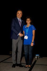 Nikita shakes hands with Kumon North America President Mino Tanabe