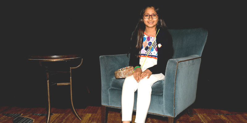 Zoha sits in a chair