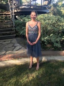 Haley poses in a dress outside of her house