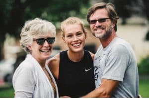 Colleen poses with her daughter and husband