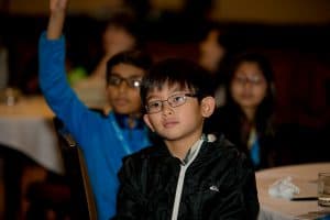 Jake watches a presentation at the student conference