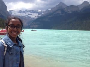 Varnica poses in front of a lake and mountain at Banff