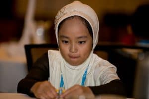 Amina concentrates on a task at the student conference