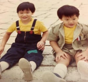 Rico and Jason sit in yellow shirts as children