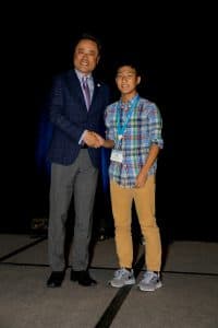 Ryan shakes hands with Kumon North America President Mino Tanabe