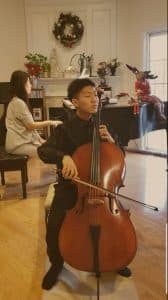 Ryan plays the cello on stage