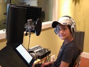 Yasseen sits in a recording studio 