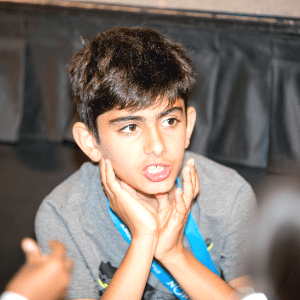 Rodean talks in his seat at the student conference