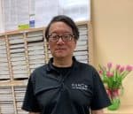 Sherman stands in front of worksheet shelves in his center