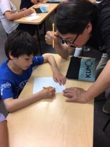 Sherman helps a student in the center