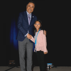 Anna shakes hands with Kumon North America President, Mino Tanabe.