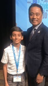 Aryan stands next to the President of Kumon North America, Mino Tanabe