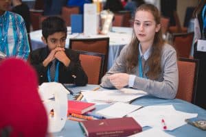 Sophia speaks at her table at the student conference 