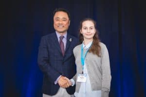 Sophia shakes hands with Kumon North America President Mino Tanabe