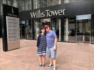 Laura and her husband pose in front of the Willis Tower