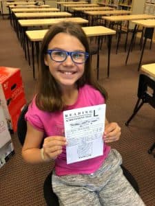 Zosia holds her Kumon Reading Level L test