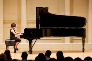 Casey plays the piano at a recital