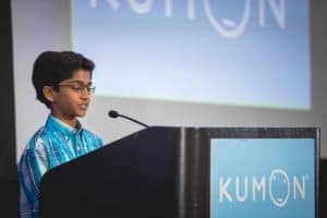 Shaylen speaks at a podium at the Student Conference