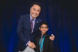 Aaron shakes hands with Kumon President Mino Tanabe