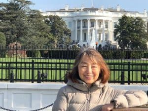 Aoi poses in front of the white house