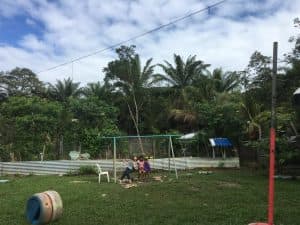 Aoi sits on a swingset in Honduras