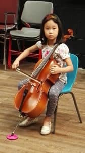 Alvina plays the cello as a young child