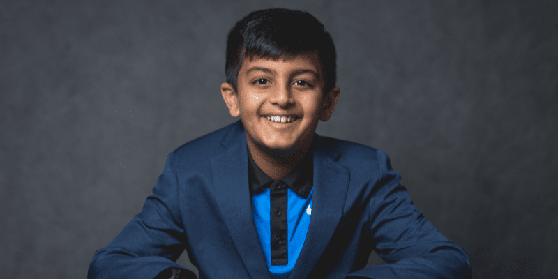 Vihaan sits in front of a gray background
