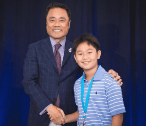Gavin shakes hands with Kumon North America President Mino Tanabe