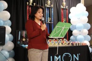 Grace speaks at a podium