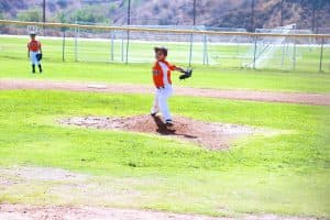 Jessica pitches in a baseball game