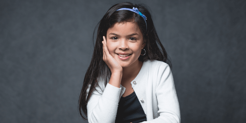 Jessica poses in front of a gray background