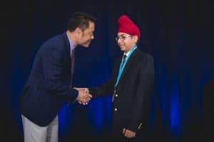 Hargoun shakes hands with Kumon North America President Mino Tanabe